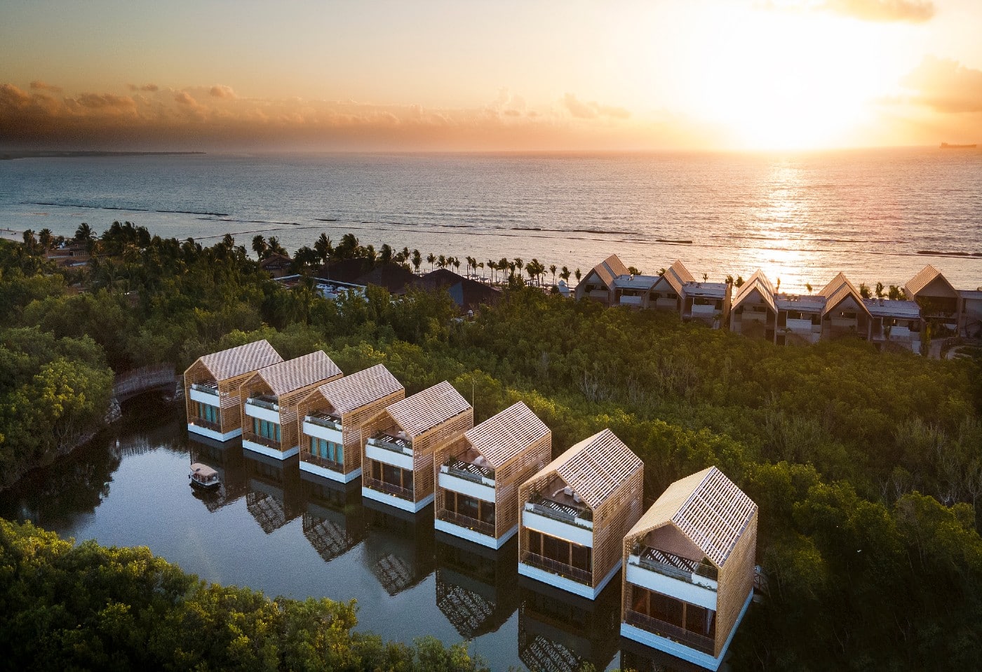 An aerial view of white lagoon villas during sunset