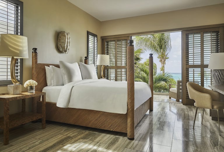 an interior view of the indoor-outdoor guest room at Four Seasons Resort Anguilla