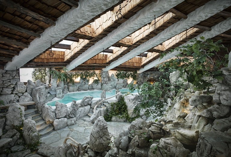 An interior shot of a pool, the rocky formations surrounding it giving it a sense of whimsy and fun.