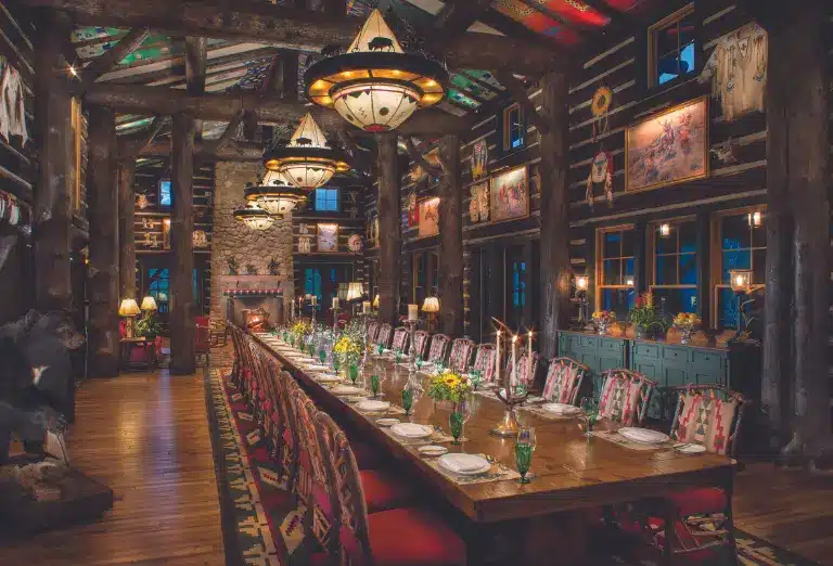 Elegant dining room at Cloud Camp with rustic decor and a long, candlelit table.