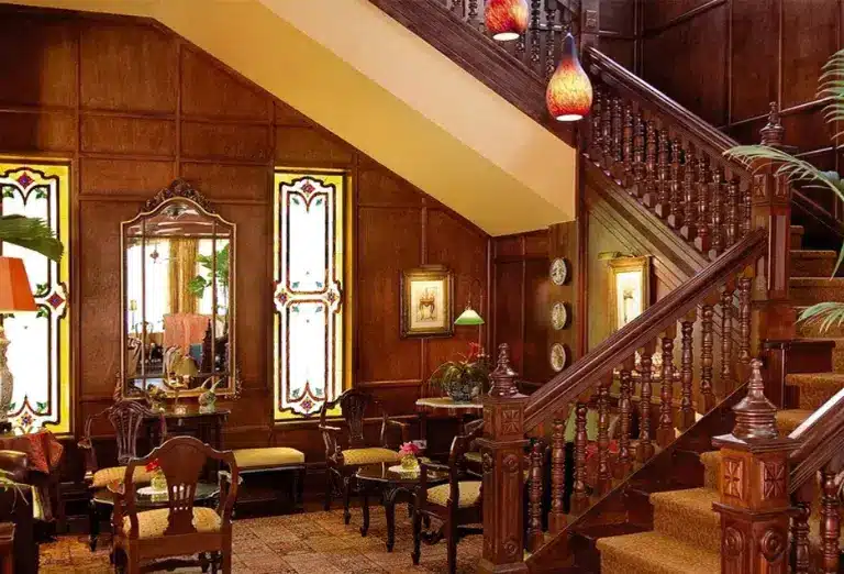 Elegant staircase with polished wooden steps leading into the Victorian Restaurant at Hotel Grano de Oro in Costa Rica.