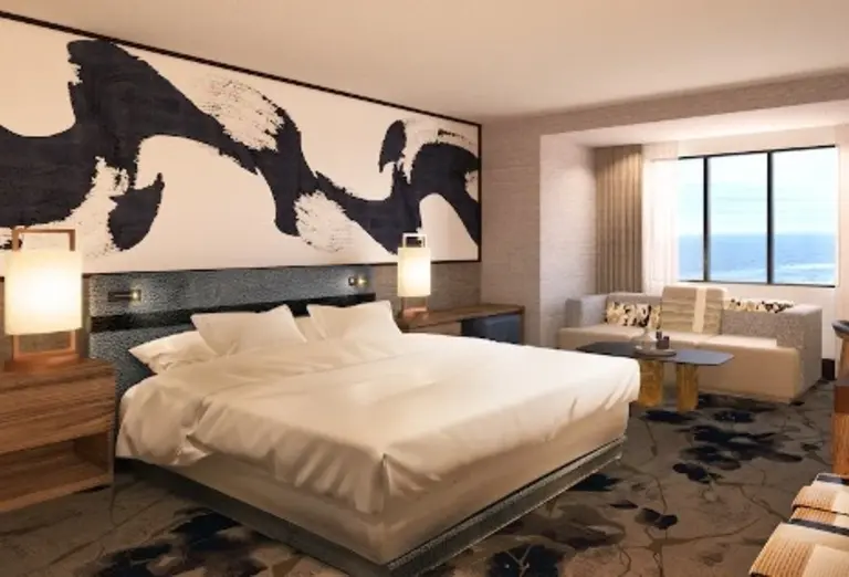 Modern room at Nobu Hotel in Atlantic City, NJ, with a large bed, abstract mural, and ocean view from the seating area.