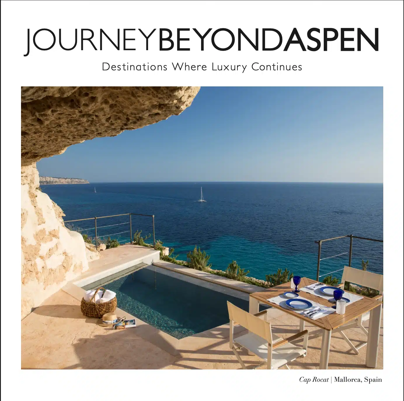 Summer 2026 magazine cover for Journey Beyond Aspen, titled "Destinations Where Luxury Continues." The cover image features a luxurious private stone patio at Cap Rocat in Mallorca, Spain, carved into a sandstone cliff overlooking a deep blue ocean. The patio features a private plunge pool and a modern wooden dining table elegantly set for two.